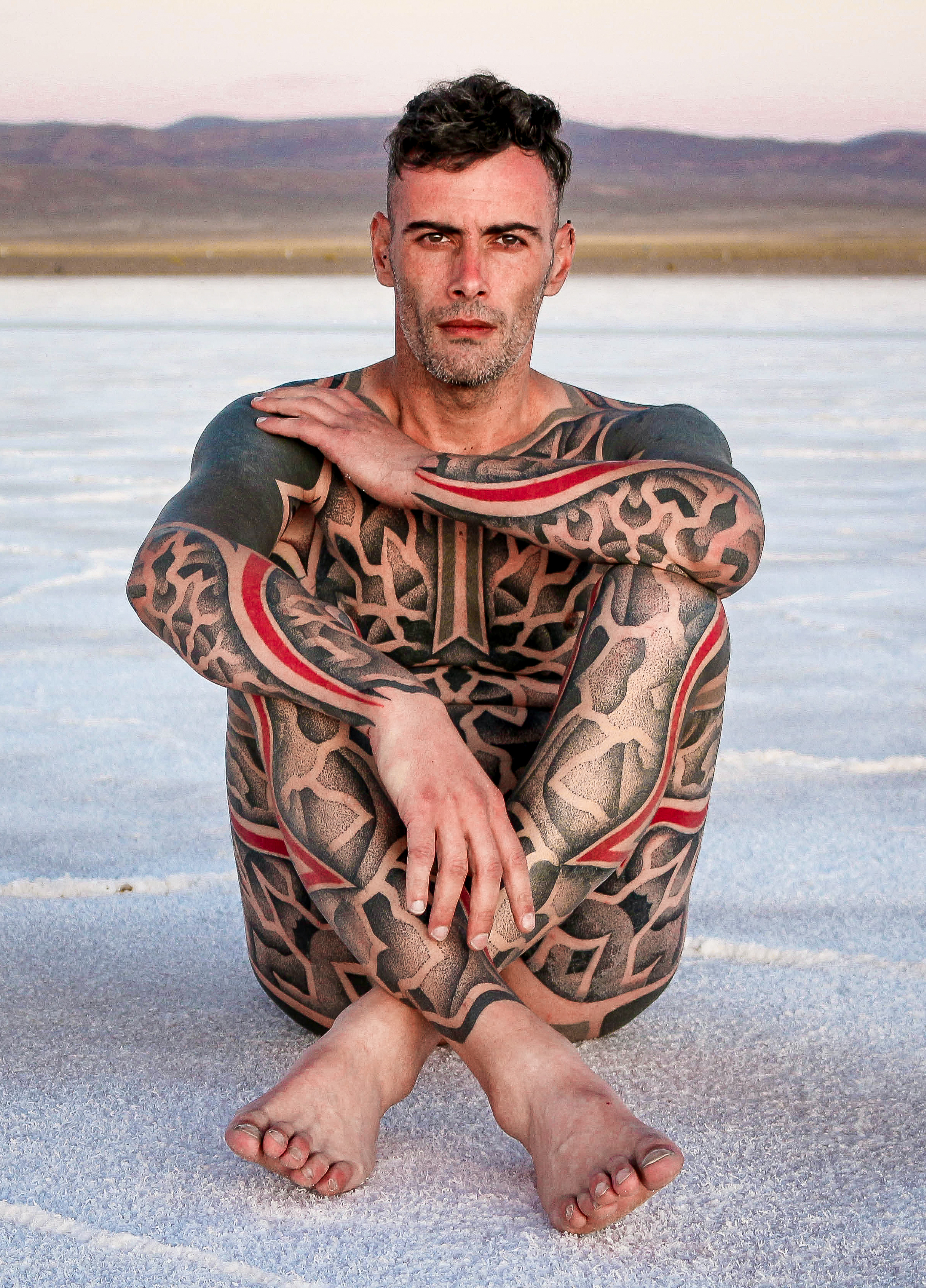 Man with a geometric full body tattoo