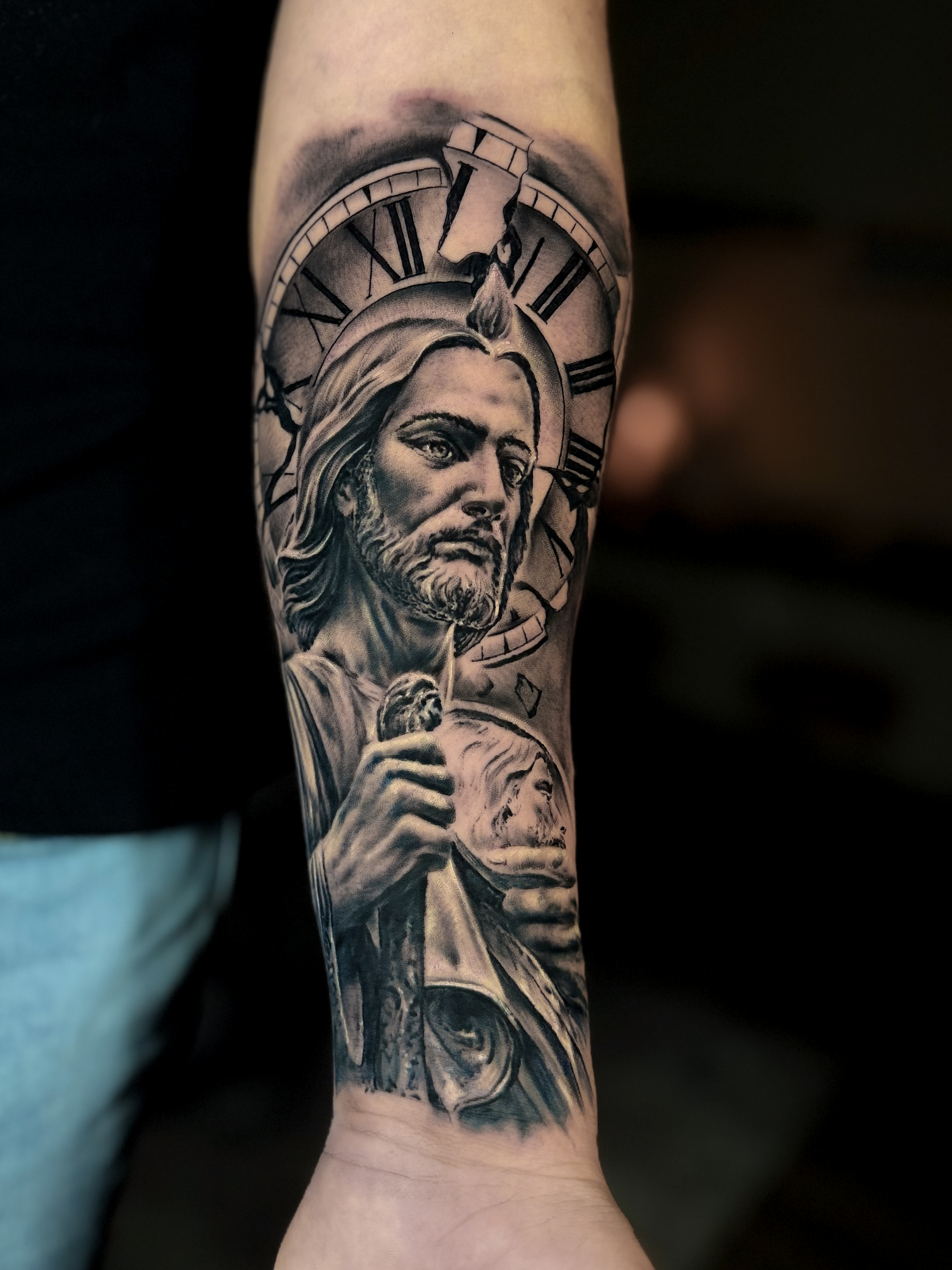 Forearm tattooed with the image of Saint Jude Thaddeus