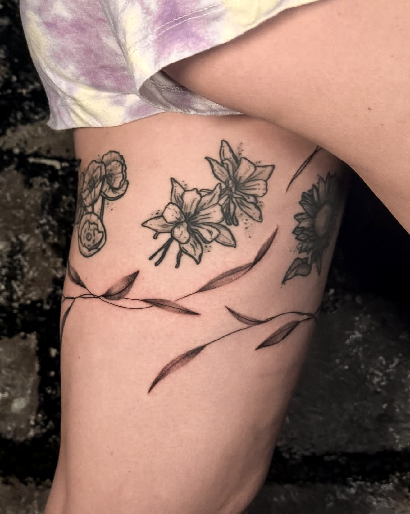 Fine line floral tattoo by Addison Powell at Diroka Tattoo Studio