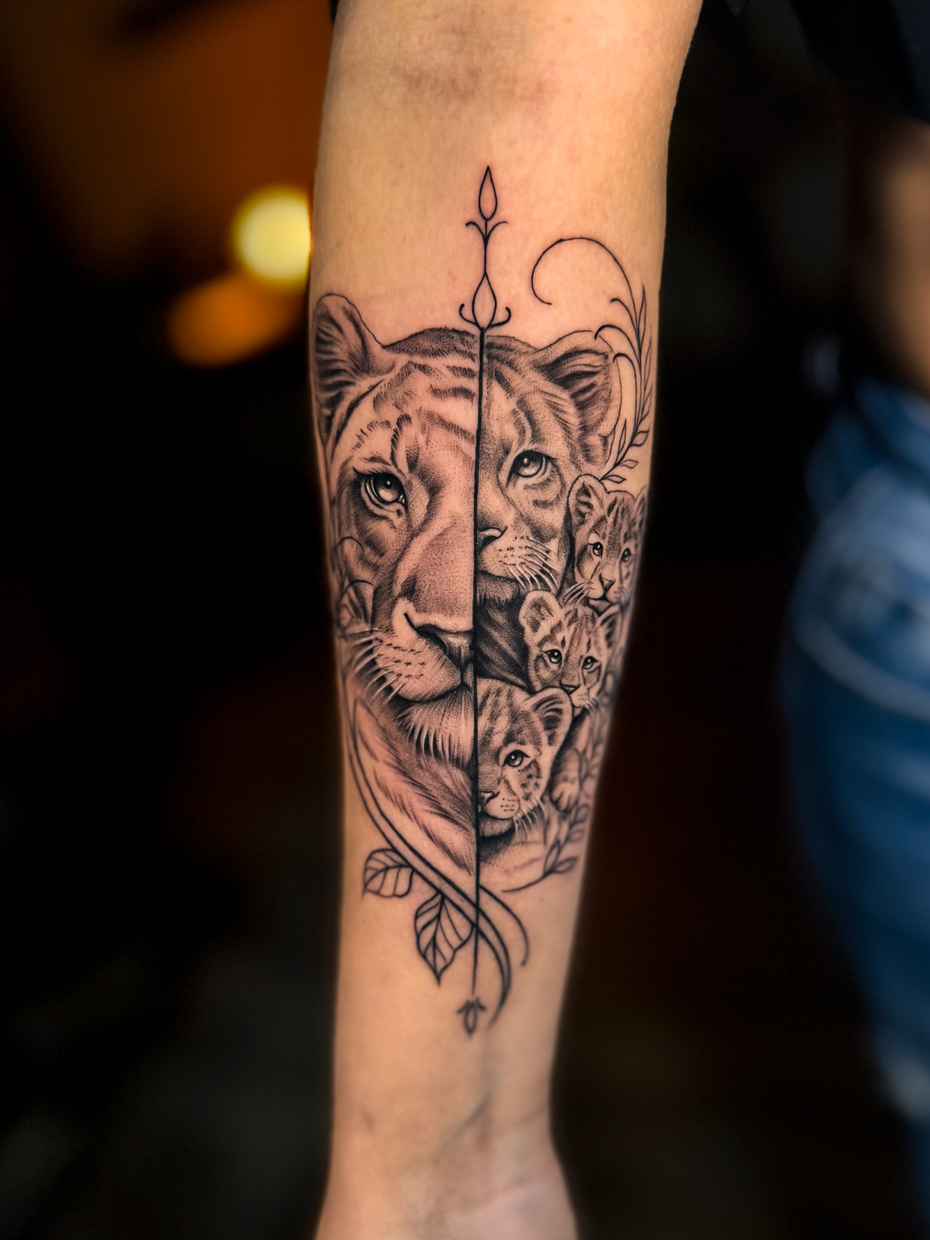 Fine line lioness and cubs tattoo by Eliana Brito at Diroka Tattoo Studio