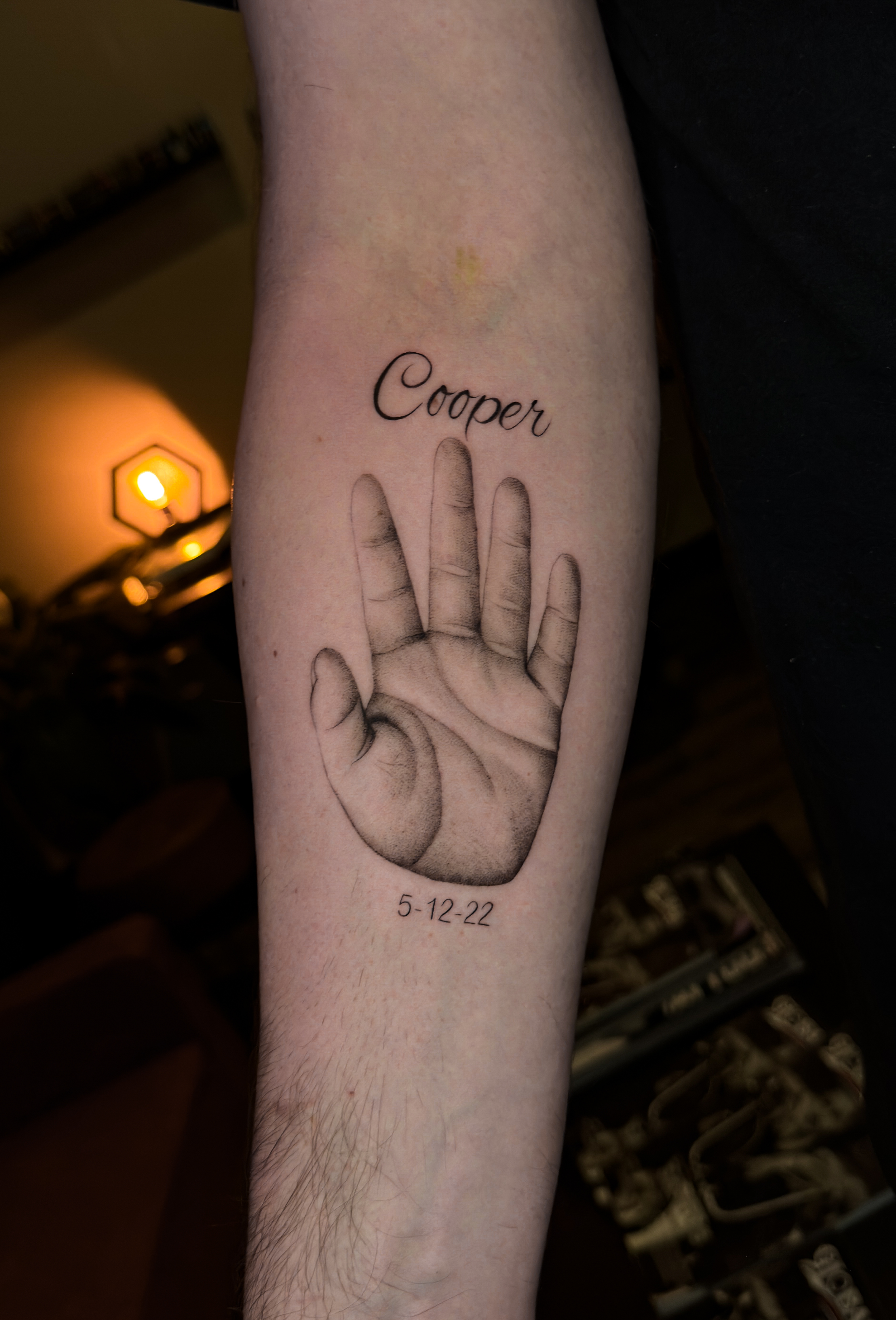 Fine line baby handprint memorial tattoo by Julian at Diroka Tattoo Studio