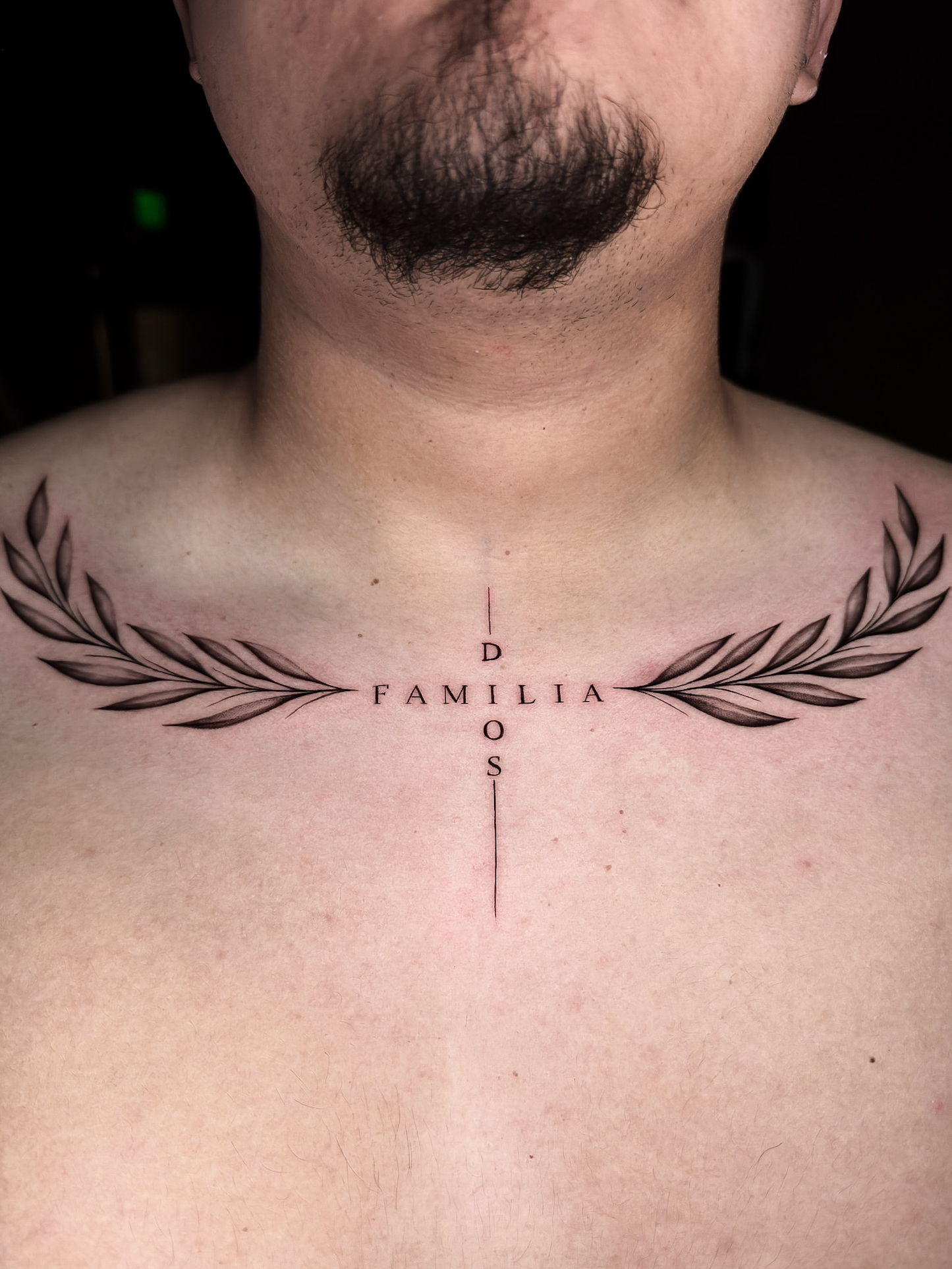 Minimalist fine line lettering chest tattoo by Julian at Diroka Tattoo Studio