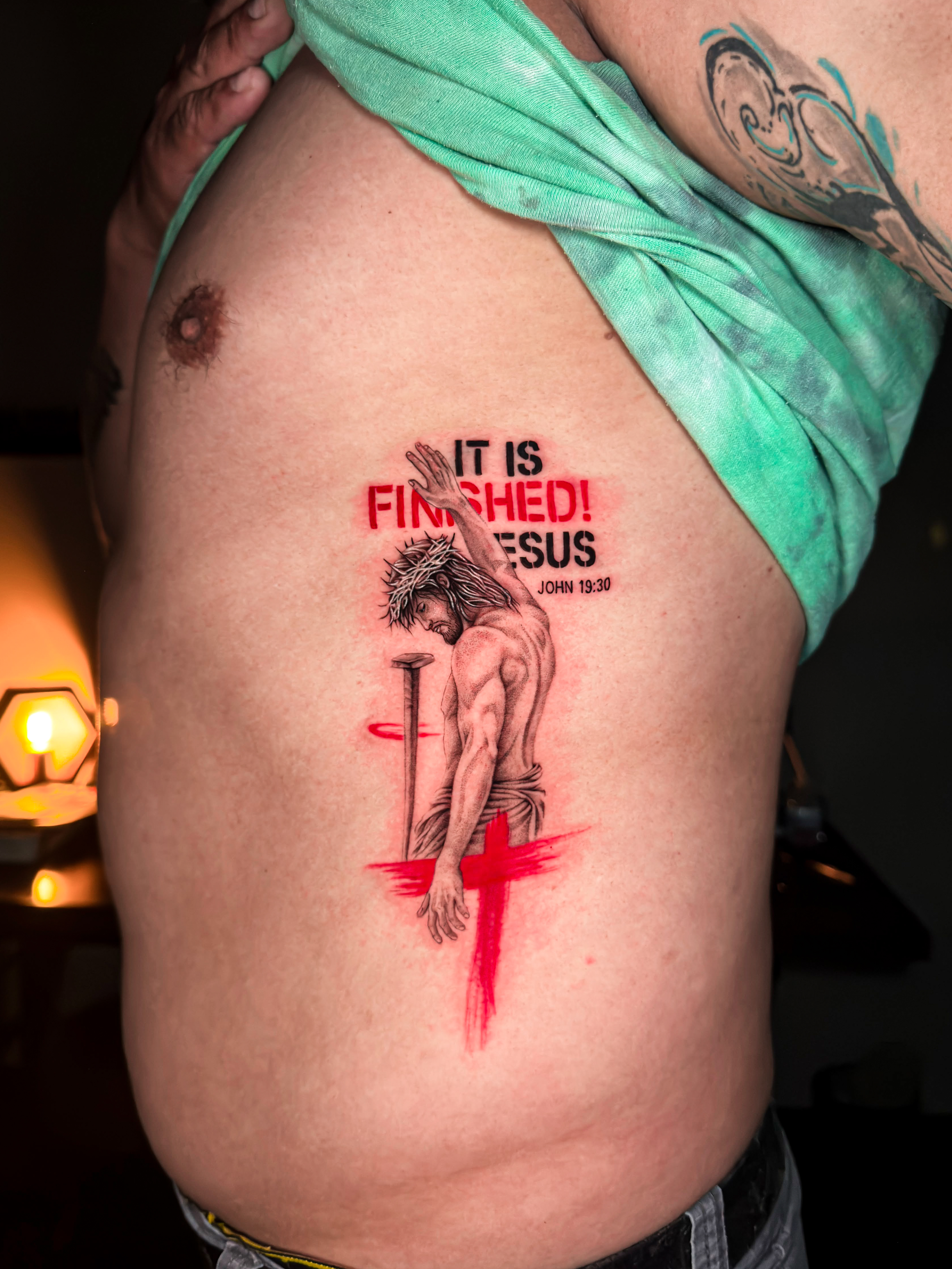 Religious Jesus realism tattoo with red accents by Julian at Diroka Tattoo Studio