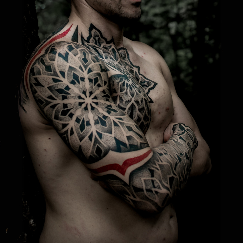 Geometric mandala design blending black, grey, and striking red lines for a powerful visual impact.